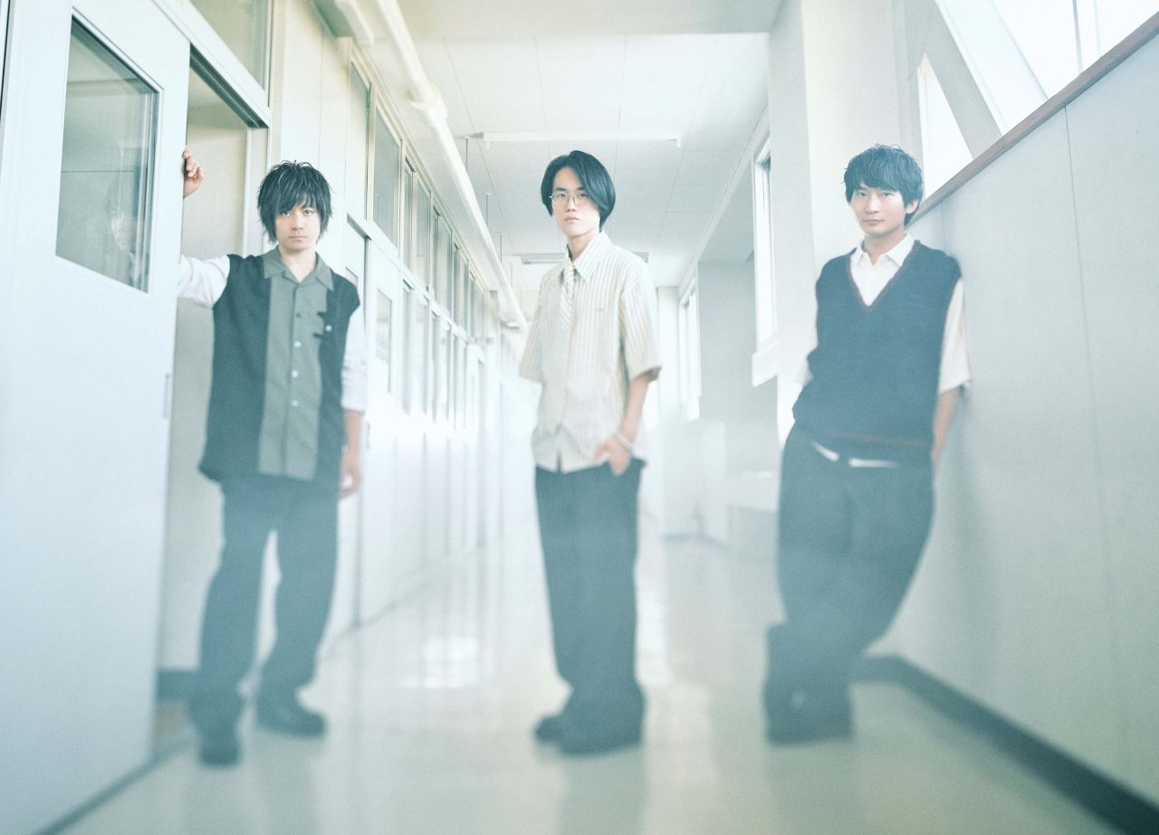The three members of BURNOUT SYNDROMES photographed in a bright corridor