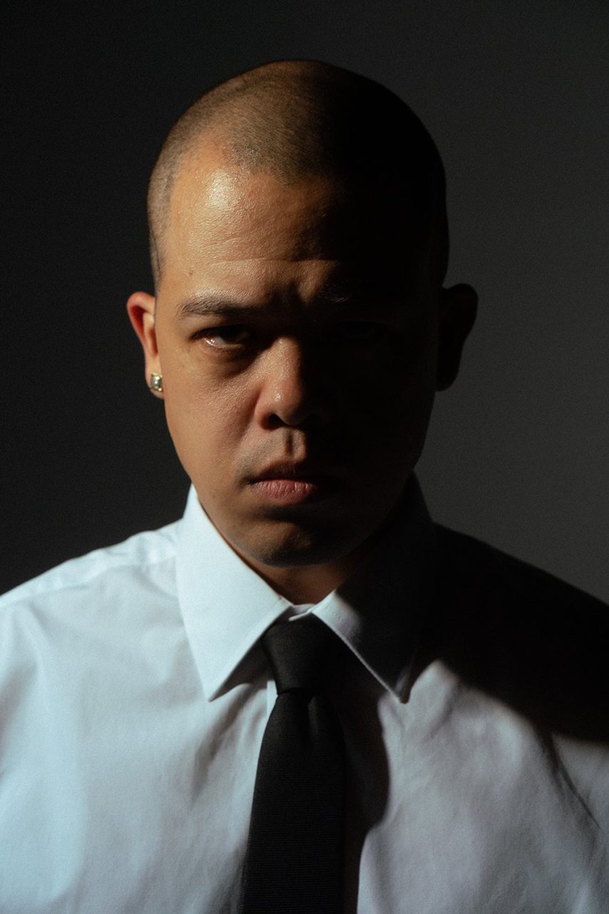 MIYACHI, official press portrait in a white shirt and black tie